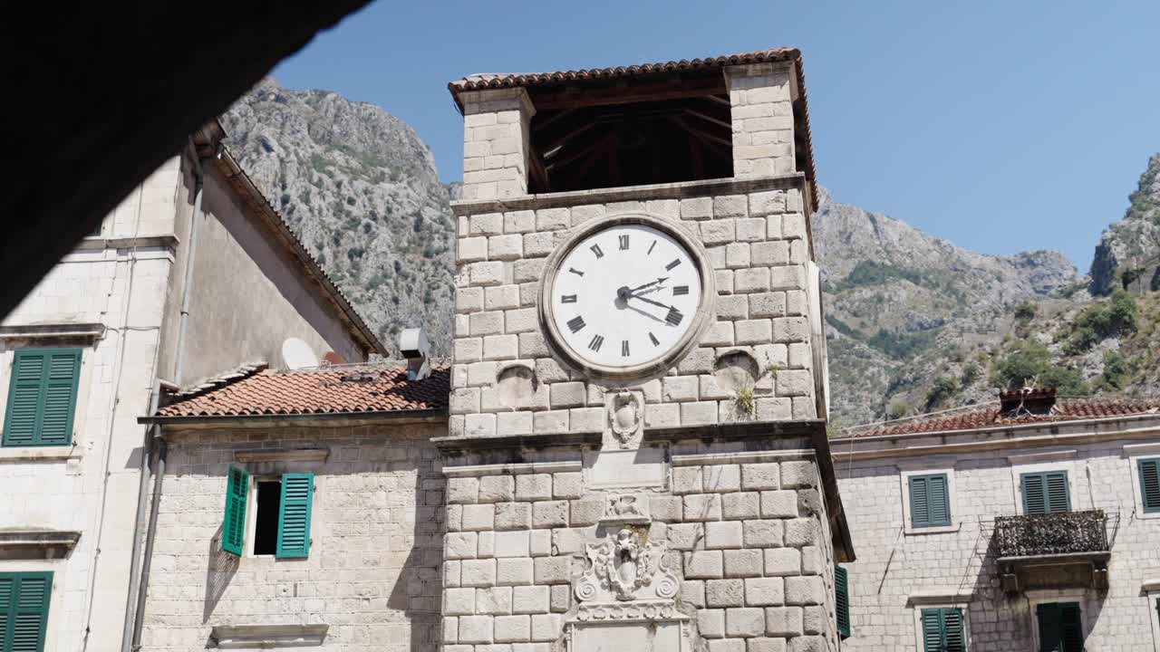 Revealing view on the Clock Tower right after the sea gate entrance of Kotor City walls and old Town in Montenegro during summertime whats a beloved sightseeing spot for tourists attraction