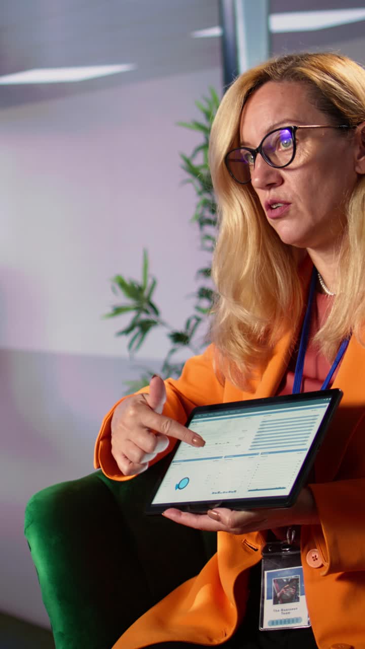Businesswoman Presenting Data and Charts on Digital Tablet