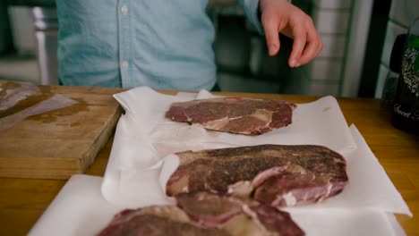 close up view of removing the steak from the bag and pat very dry with paper towels