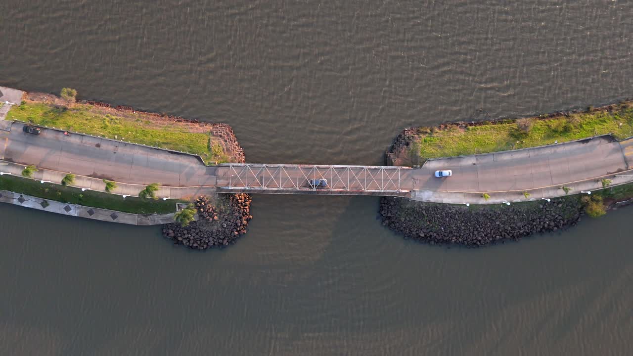 Drone shot capturing the scenic landscape of federacion city in entre rios province, argentina, highlighting a bridge over a river and lush surroundings