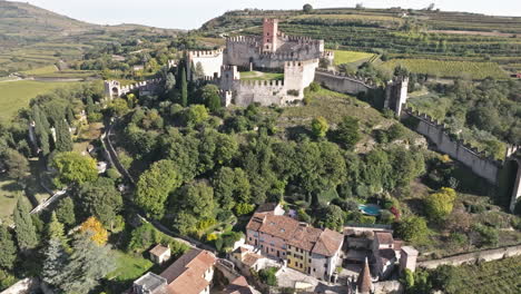 imposing scaliger castle with historic walls surrounded by green vegetation in soave, verona italy