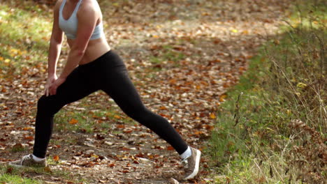 woman jogger stretching legs after running