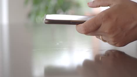 woman using a smartphone at a table