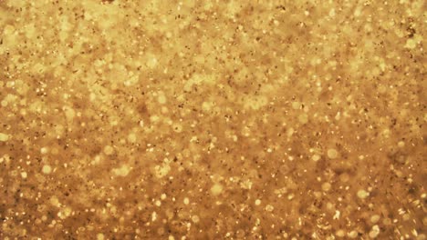 abstract golden particles with blurred defocused bokeh moves chaos, snow flakes