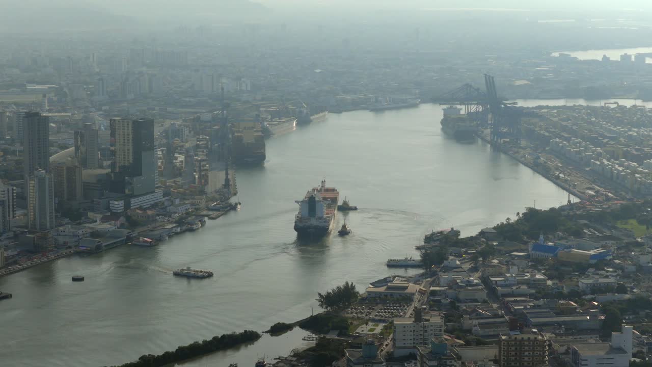 downward-angled aerial clip approaches vessel at Port of Itajaí during sunrise, showing ship moving amid ongoing construction