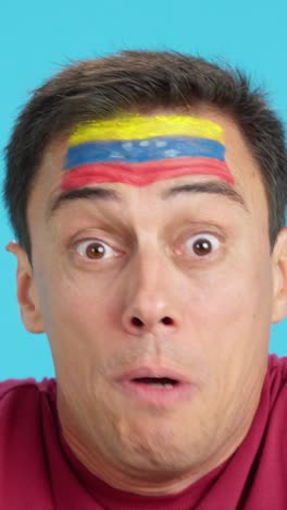man with venezuelan national flag upset with a referee