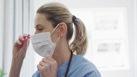 Female-health-worker-wearing-face-mask-at-home