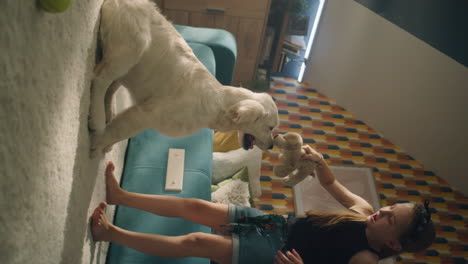 girl playing with her golden retriever dog