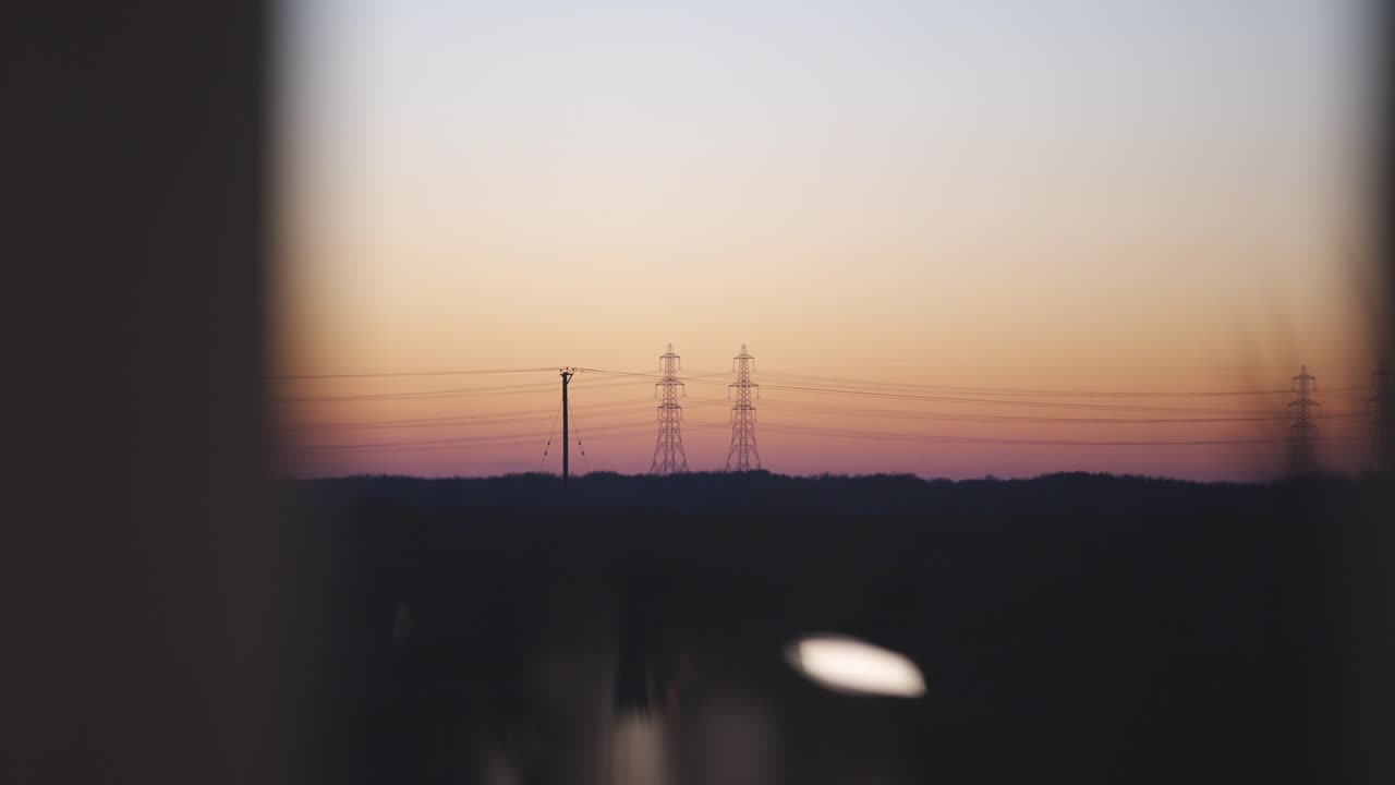 Pylon silhouettes against sunset sky