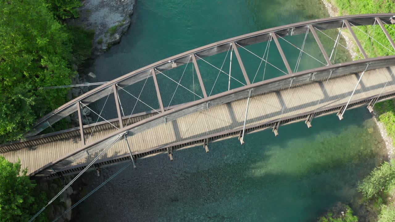 Aerial View of a Wooden Arch Bridge over a Crystal-Clear River