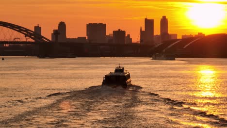 sunset over city river with ferry