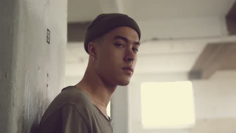 fashionable young man in an abandoned warehouse