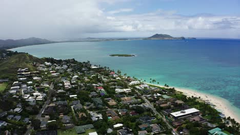 Drone-shot-of-a-Hawaiian-neighborhood-lining-Lanikai-Beach-on-the-shores-of-Oahu