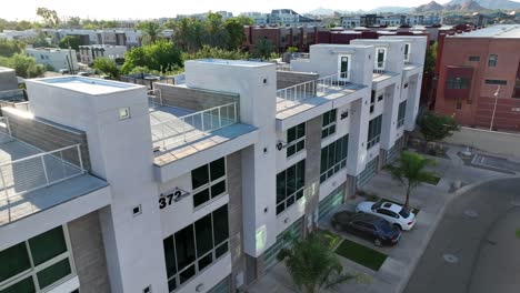 modern white apartments with palm tree landscaping in urban american city in usa