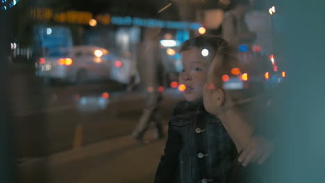 woman and boy waiting for a bus