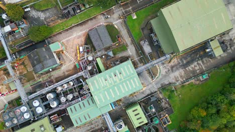 aerial footage advances toward a massive uk chemical facility, revealing pipelines, metal structures, cooling towers, and chemical storage