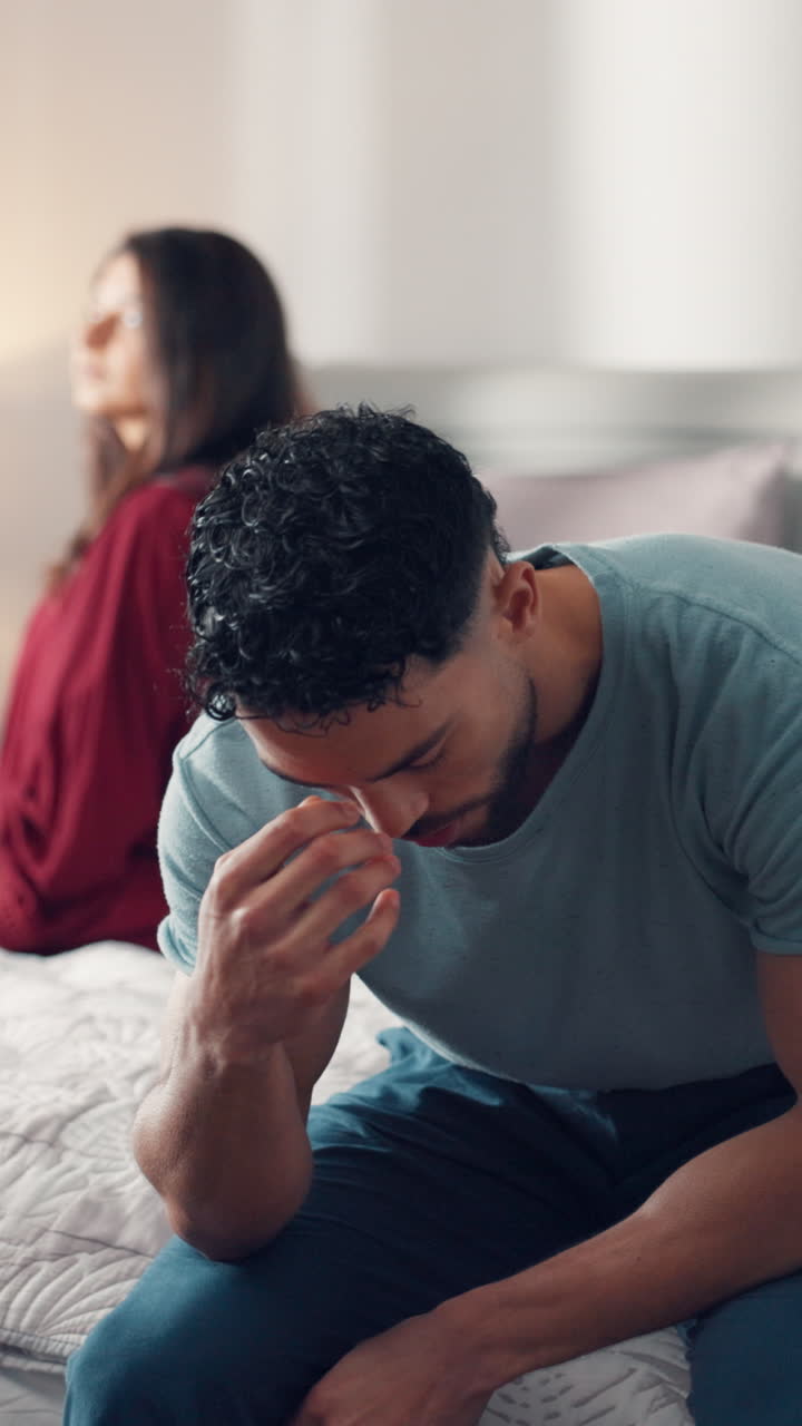 Upset Couple Sitting on Bed After an Argument