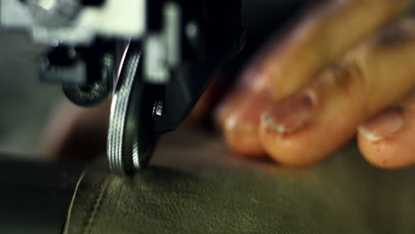 sewing process of the leather shoes. close up man hands behind sewing