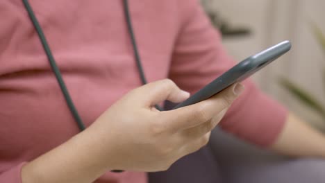 detail of female hands using cell phone