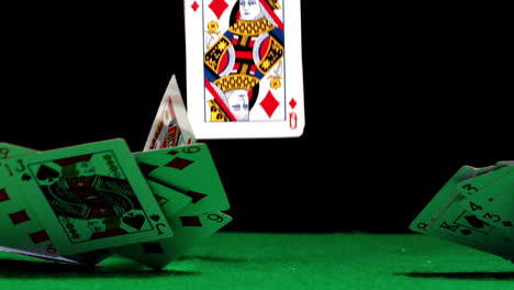 deck of cards falling on casino table