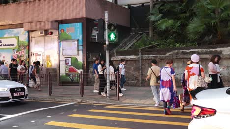 pedestrians crossing at a busy intersection