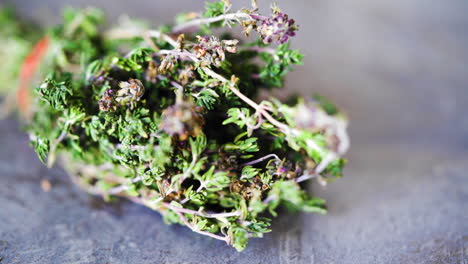 close up, shallow depth of field shot of thyme being picked up