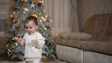 baby playing near christmas tree