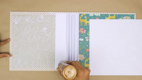 Assembling-a-baby-scrapbook-with-glue