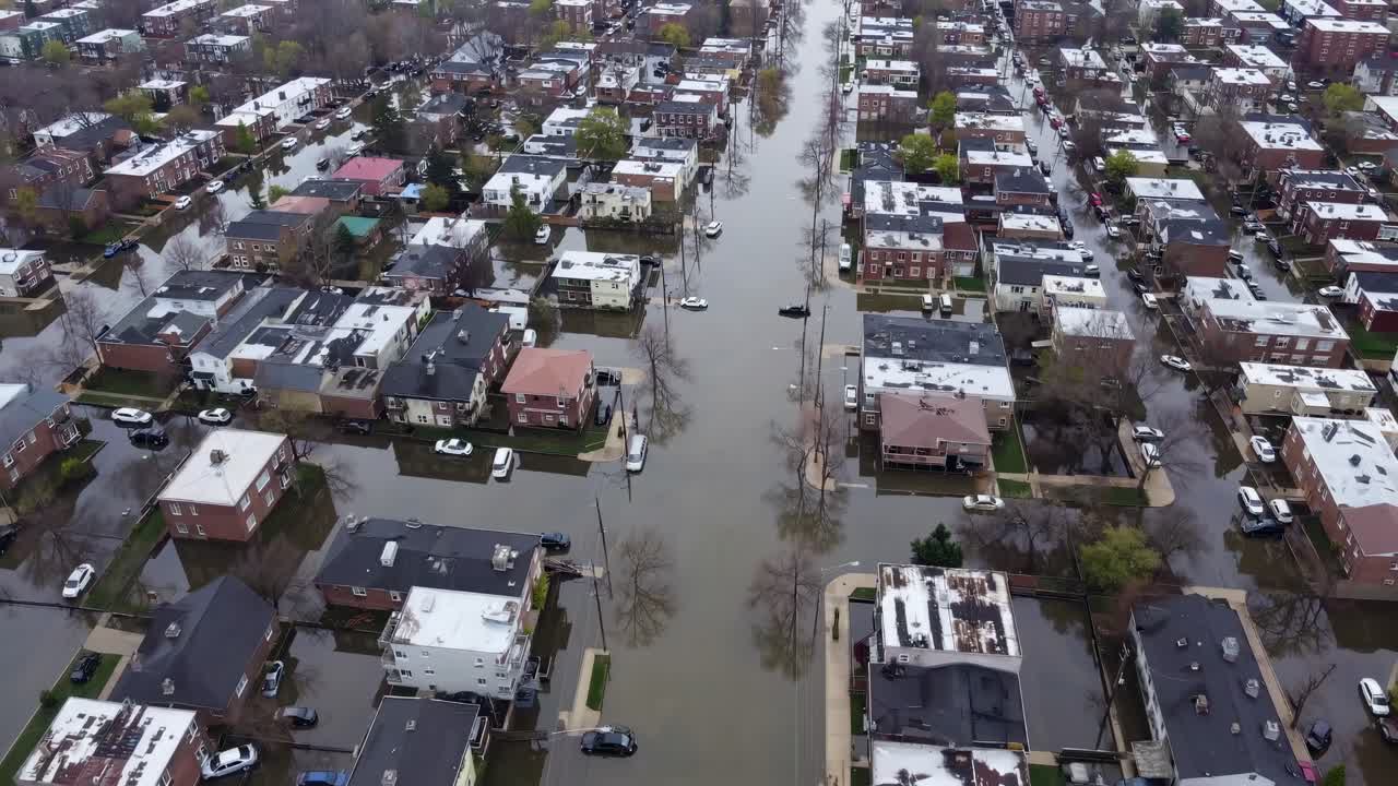 Aerial view of a flooded residential area, showcasing submerged streets and houses