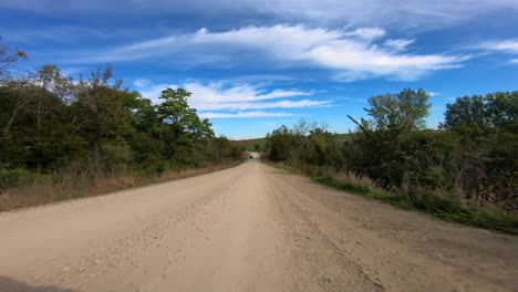 pov through driver's window while driving through rural iowa