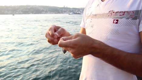 the fisherman preparing the fishing rod 3