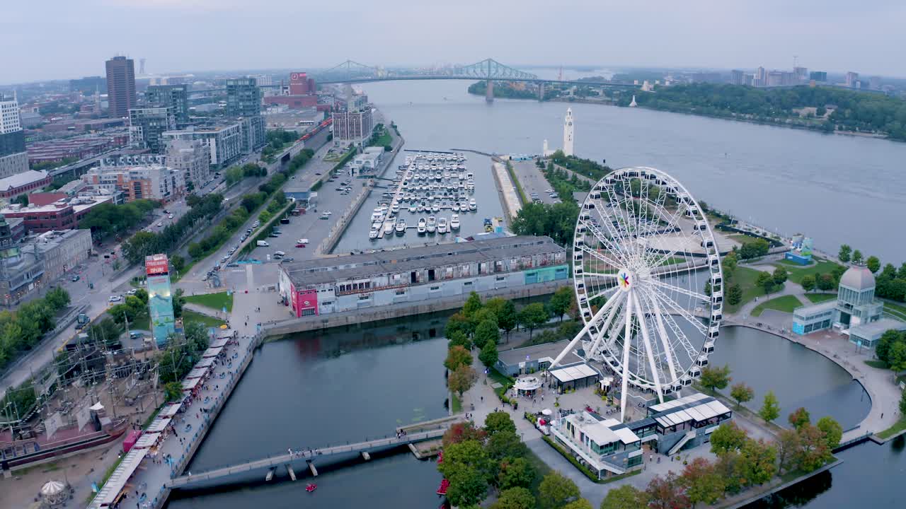 Aerial shot of Montreal's Old Port with the Ferris wheel in view, showcasing the vibrant waterfront and historic architecture. Perfect for capturing the essence of the city.