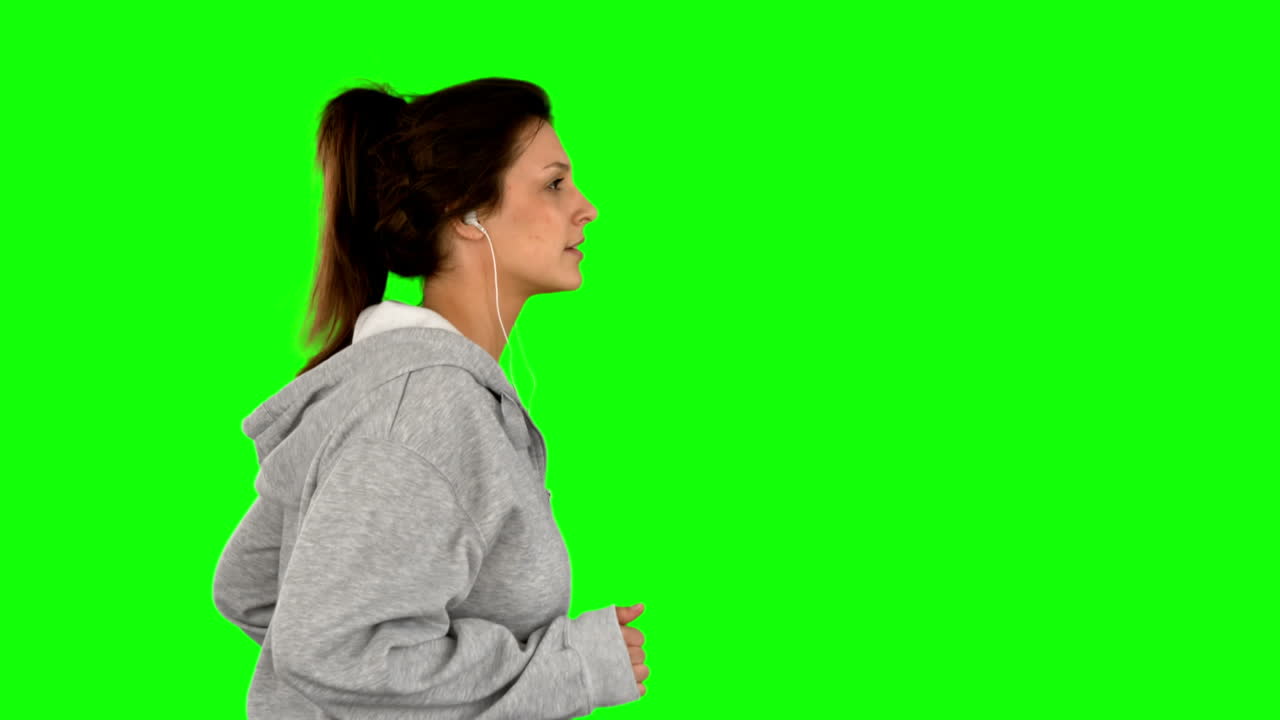 Fit woman jogging on green screen