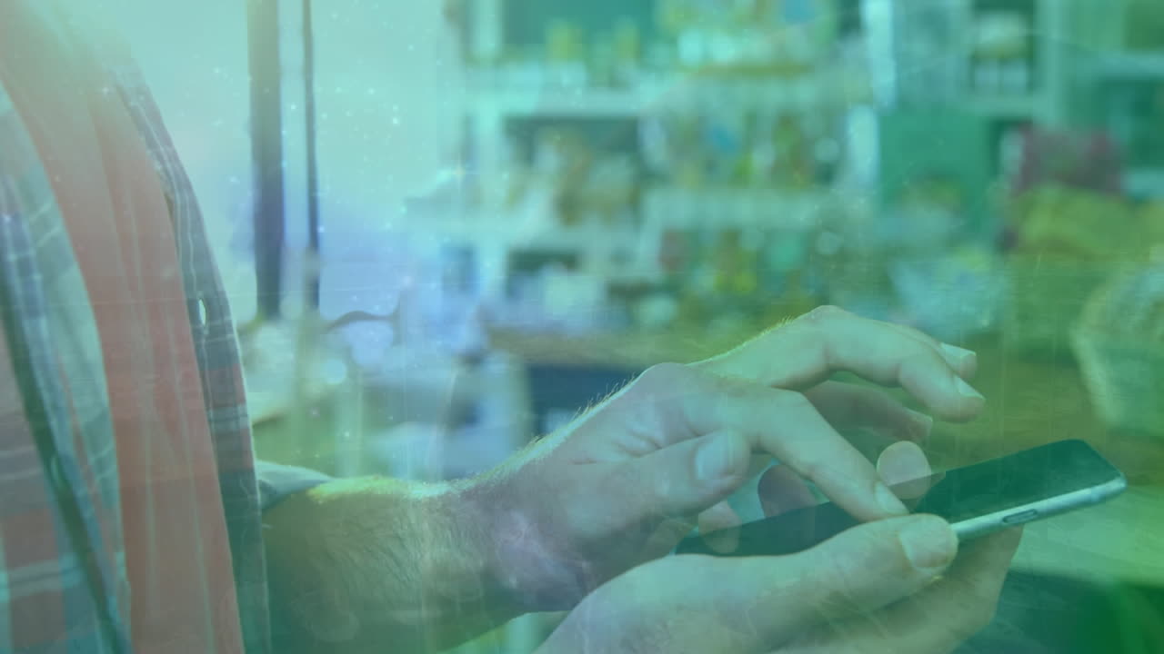 animación del globo sobre el hombre de negocios caucásico usando un teléfono inteligente