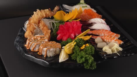 a beautifully arranged platter with shrimp tempura rolls, salmon and tuna sashimi, and flavorful nigiri. 아름답게 담긴 플래터에 새우튀김 롤, 연어·참치 사시미, 감칠맛 나는 초밥이 조화롭게 어우러짐.
