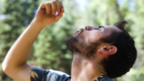 Toma-En-Cámara-Lenta-De-Un-Hombre-Metiéndose-Una-Cereza-En-La-Boca-Y-Masticándola-2