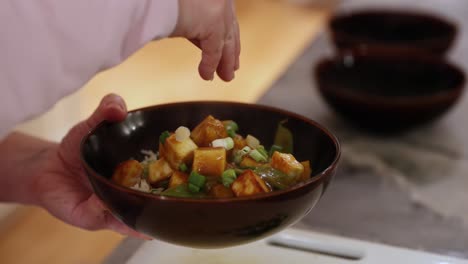 Woman-Adding-Green-Onion-To-Rice-And-Cooked-Vegetables-In-4K