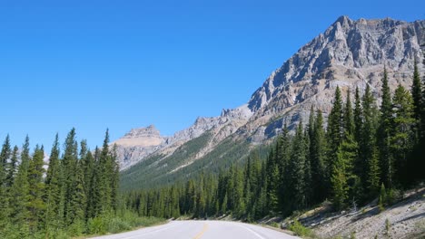 view from the front of the car while moving along the icefield parkways in banff national park, canada