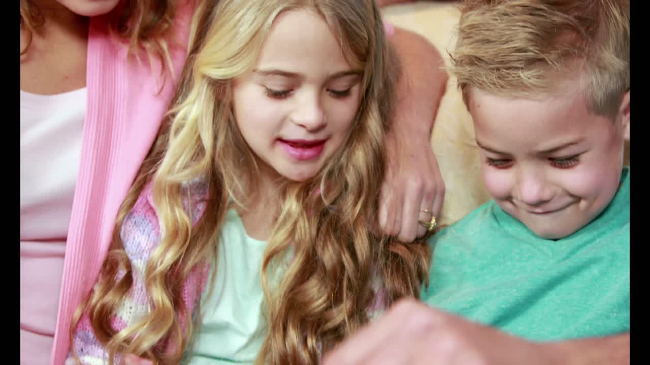 Happy family using tablet on the couch