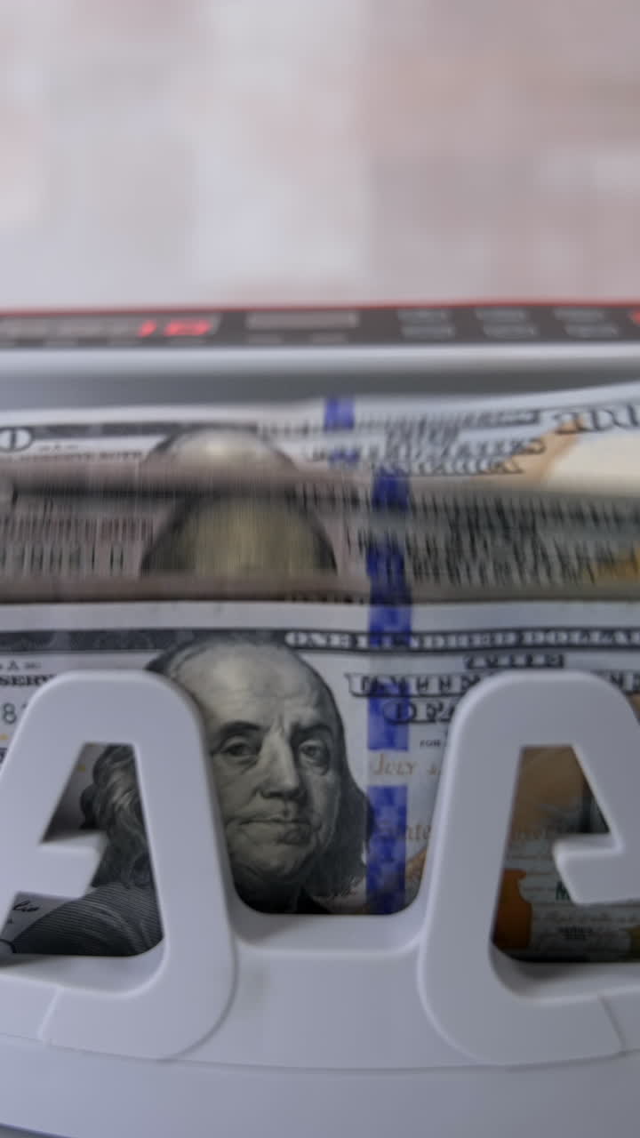Money counting machine. Counting dollar banknotes. Vertical video