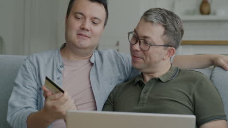 happy gay couple online shopping