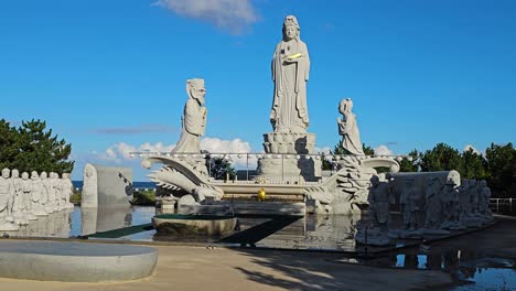 zoom in to avalokiteshvara or hyuhyuam sea guanyin statue at hyuhyuam hermitage buddhist temple in south korea, devout figurines worship and learn at peaceful altar