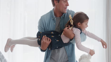 happy-father-holding-little-girl-pretending-to-fly-playing-fun-game-with-dad-at-home-4k