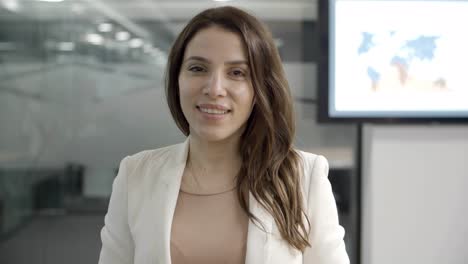 beautiful young businesswoman looking at camera and nodding