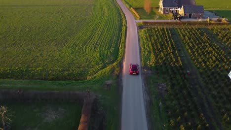 aerial drone shot of alfa romeo car driving underneath and away from drone