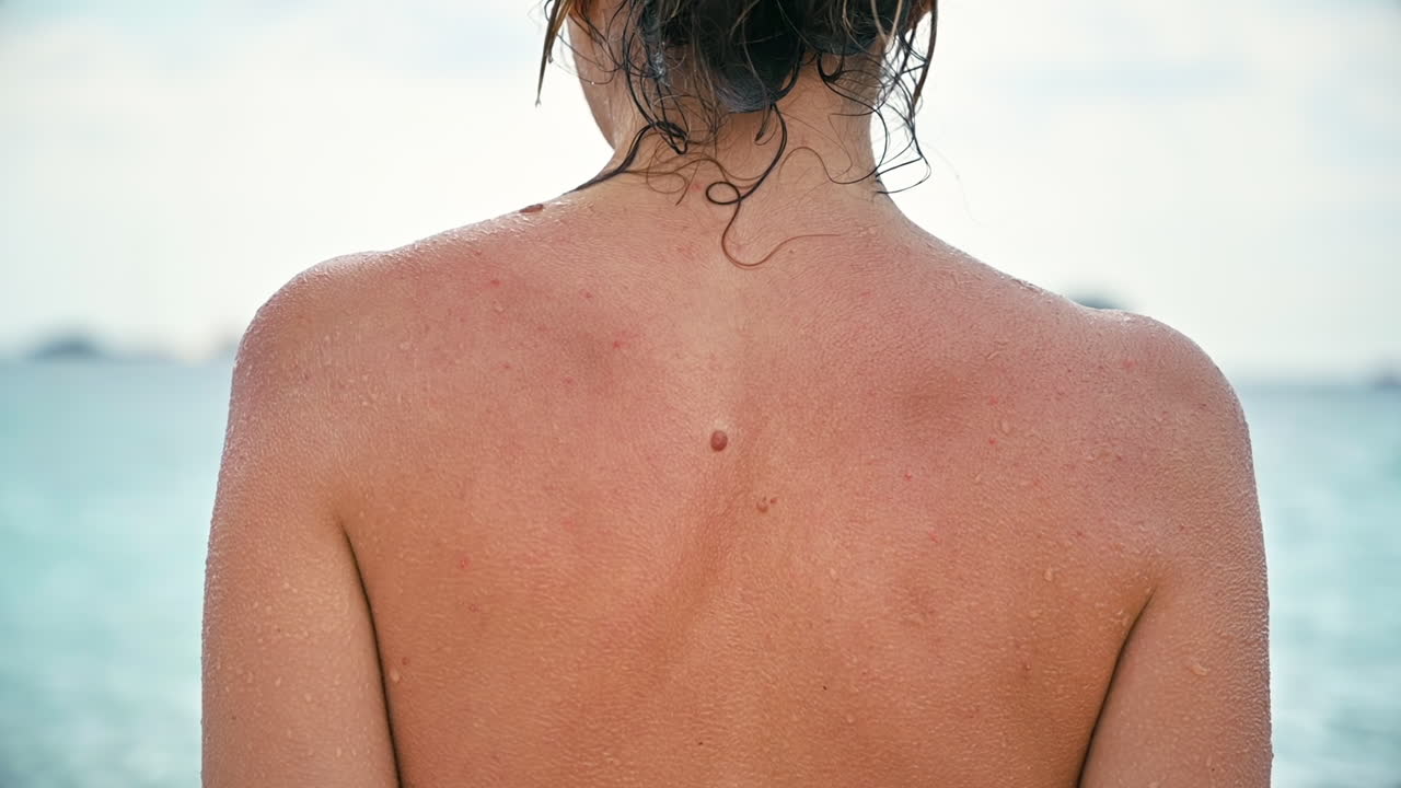 Close view of woman wet back on a sea coast. Slow motion