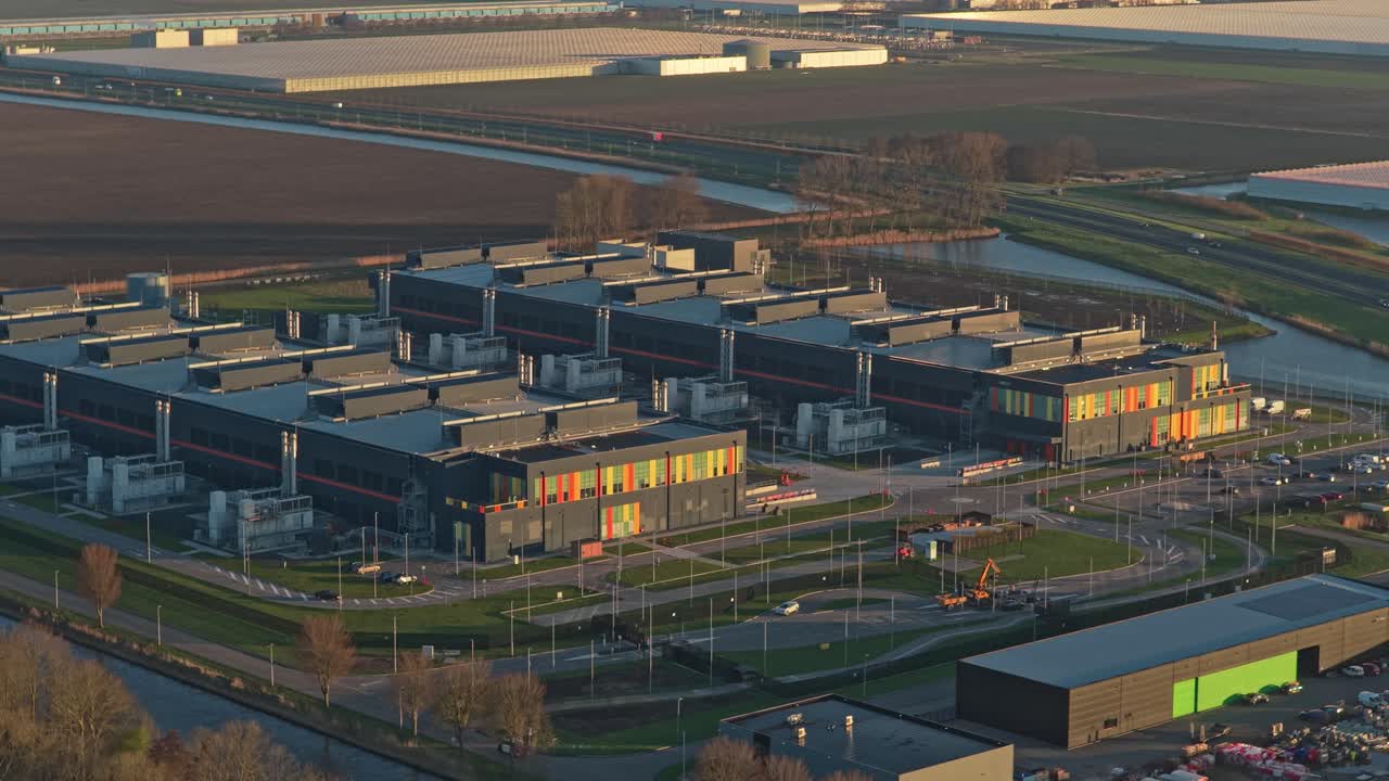 Aerial view of a large data center complex at sunrise