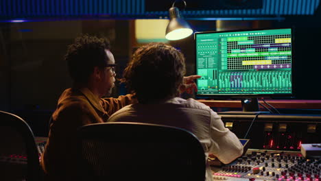 Team of sound engineers working on recording and editing tracks