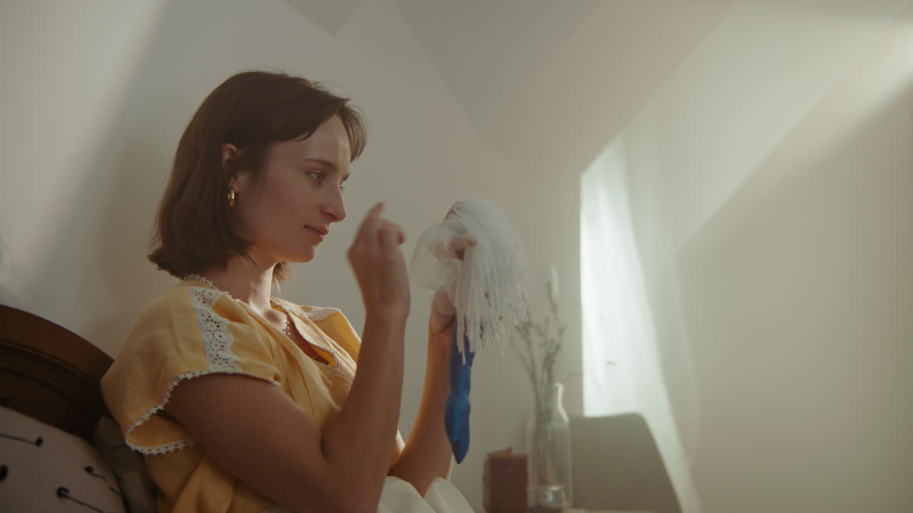 A girl playing with dolls in her room