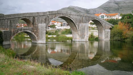 ancient medieval stone bridge called arslanagic bridge over the trebisnjica river in trebinje, bosnia and herzegovina